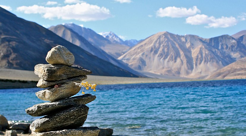 Tourists enjoying a camel safari on double-humped Bactrian camels in the sand dunes of Nubra Valley.