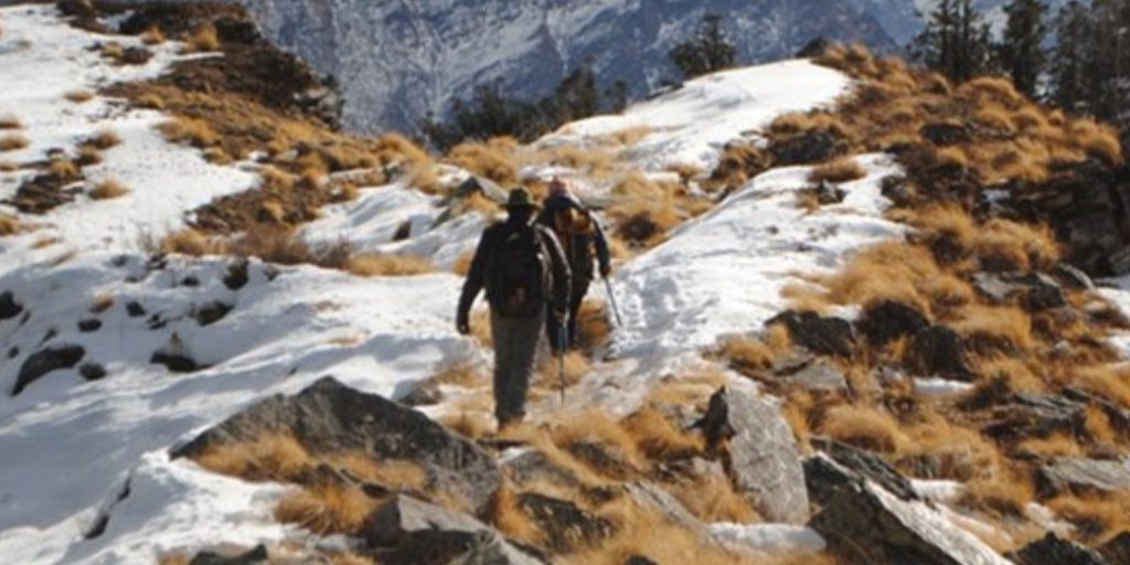 Kuari Pass Trek in winter with snow-covered trail and views of Mt. Nanda Devi